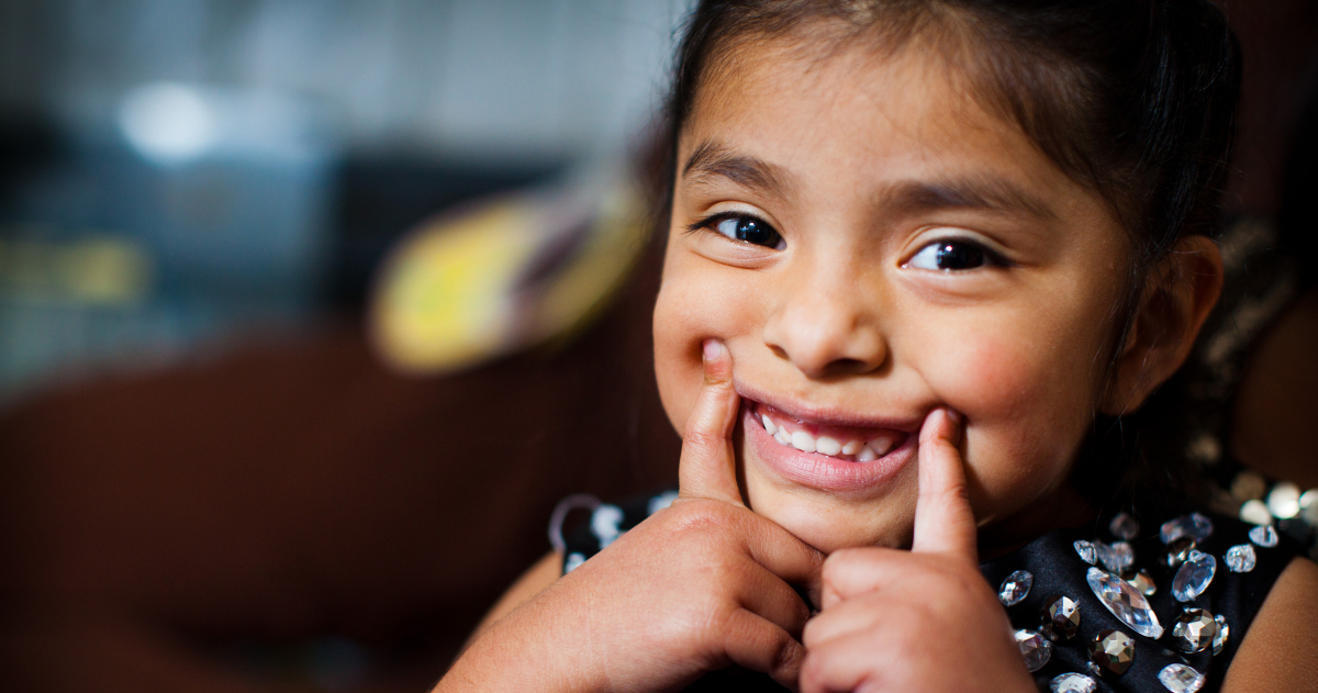 Hispanic child smiling after receiving dental care