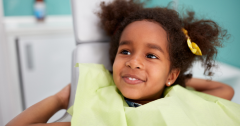 Black girl receives care from community health center dentist